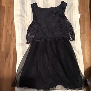 A mid length navy blue prom dress